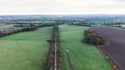 Aerial view across patchwork ploughed farmland and fields in the Autumn Suffolk Stock Footage 321517069