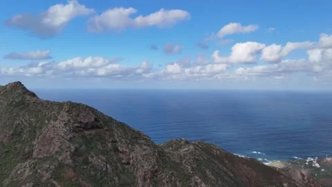 Aerial View Across a Rugged Mountain Ridge Toward the Ocean Stock Footage 345576416
