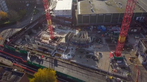 Aerial view on active construction site, two construction cranes and builders Video stock 120748040