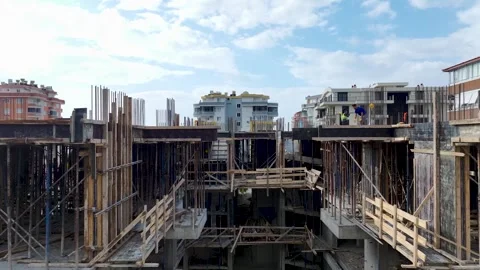 Aerial View: An active construction site with workers arranging metal Stock Footage 296053615