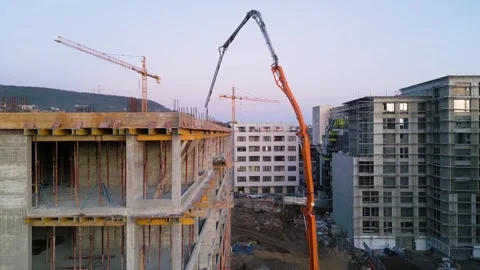 Aerial view of an active construction site featuring a high-rise building under Stock Footage 300373776