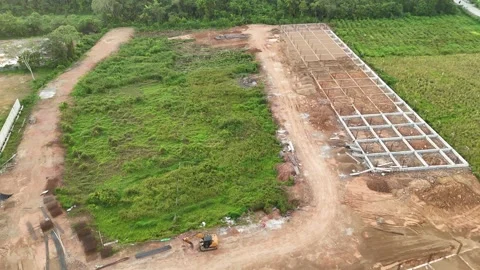 Aerial View of Active Construction Site and Tropical Trees at Dusk Video stock 347460101