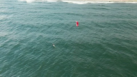 Aerial view active man practicing kite surfing and windsurfing on the sea Stock Footage 142667089