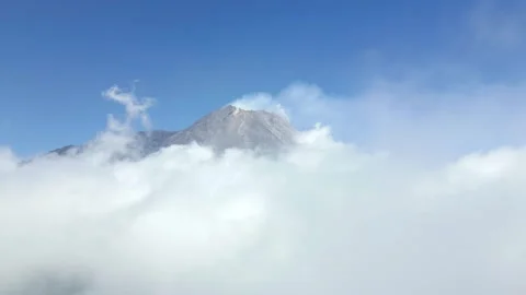 Aerial View Of Active Merapi Volcano Above The Clouds In The Blue Sky, Indonesia Stock Footage 283626437