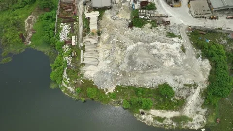 Aerial View of an Active Quarry Site and Adjacent Water Body Видео 337330054