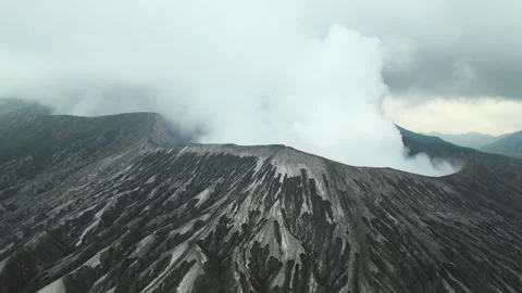 Aerial view of an active volcano with a smoking crater, solidified lava flows Stock Footage 295764022
