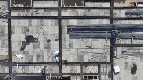 Aerial View: Aerial perspective of workers building with metal, showcasing Stock Footage 296178807