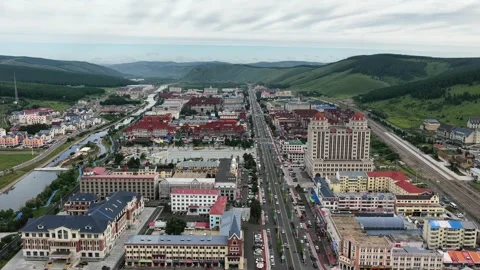 Aerial view of Aershan city between green hills in Inner Mongolia Stock Footage 340217116