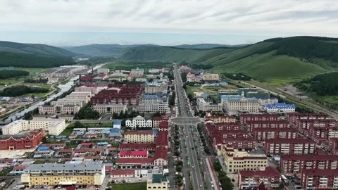 Aerial view of Aershan city between green hills in Inner Mongolia Stock Footage 340217164