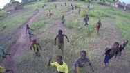 Aerial View - African Children Run After Drone Before It Flies Over The Village Stock Footage