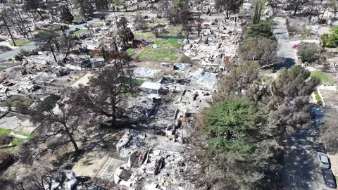 Aerial view of the aftermath of LA fires with burnt Los Angeles homes Stock Footage 306783647
