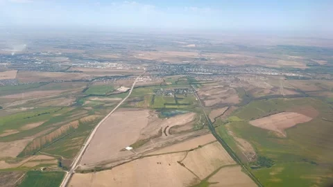 Aerial view of agricultural fields and rural landscape from airplane in 4K Stock Footage 343376230