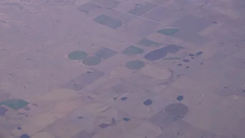 Aerial view of agricultural fields with circular irrigation patterns Stock Footage 346008747