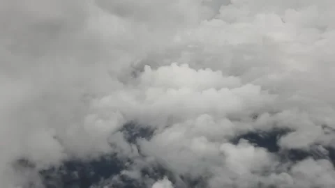 Aerial view from airplane of cumulus cloudscape seen from a window plane Stock Footage 326551413