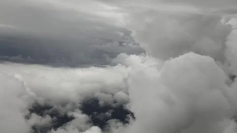 Aerial view from airplane of cumulus cloudscape seen from a window plane Video stock 326704342