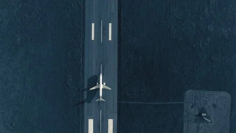 Aerial view of the airplane on take-off approach at the airport runway. top view Stock Footage
