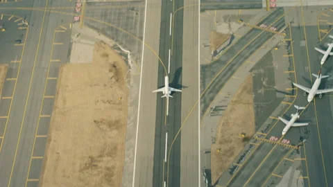 Aerial view of an airplane taking off into flight from airport runway into the s Stock Footage 199457701
