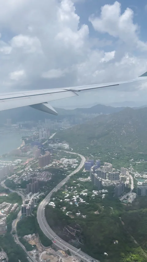 Aerial view from airplane window above Hong Kong city background. Stock Footage 280913050