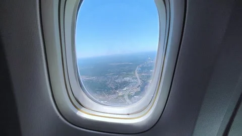 Aerial view from airplane window above green ground, city and river. Stock Footage 282119909