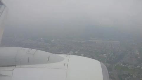 Aerial view from an airplane window during a cloudy descent over Warsaw, Po.. Stock Footage 294895909