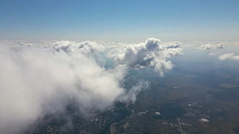 Aerial view from airplane window at high altitude of earth covered with white Stock Footage 165697495