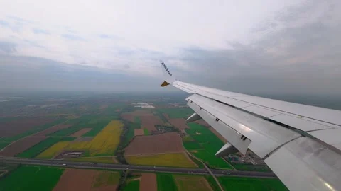 Aerial View from Airplane Window Over Patchwork Farmland During Cloudy Descent 스톡 동영상 334349935