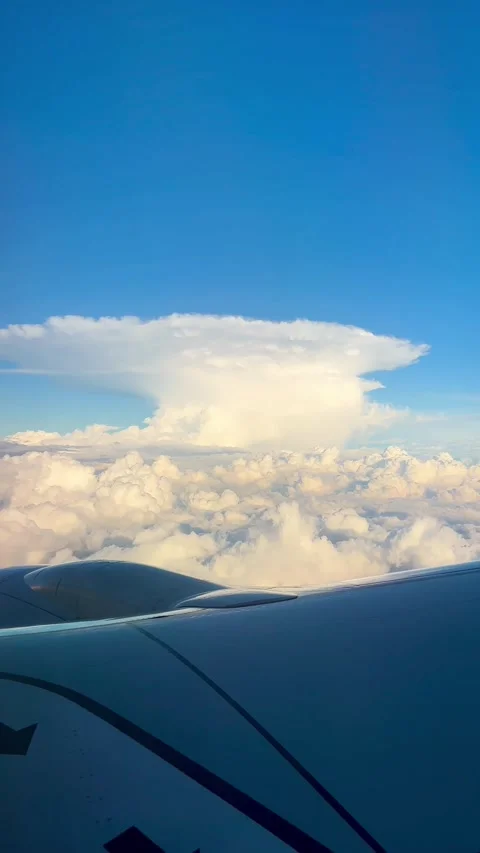 Aerial View from Airplane Window Over Clouds and Sky Stock Footage 338187552