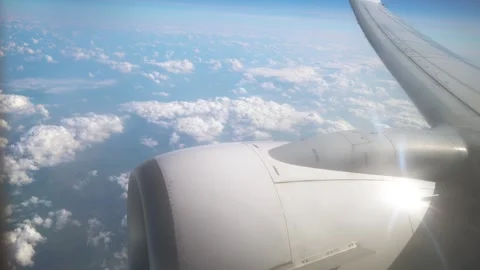 Aerial View From Airplane Window Showcasing Jet Engine and Clouds During Sunny Stock Footage 311455420