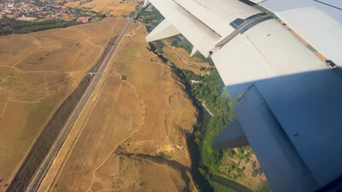 Aerial View Of Airplane Wing Flying Over Rural Landscape During Golden Hour Stock Footage 346884707