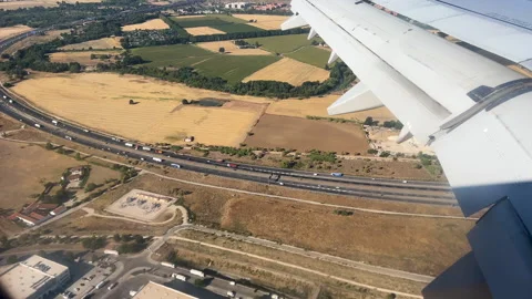 Aerial View Of Airplane Wing Flying Over Highway And Rural Landscape Stock Footage 346884745