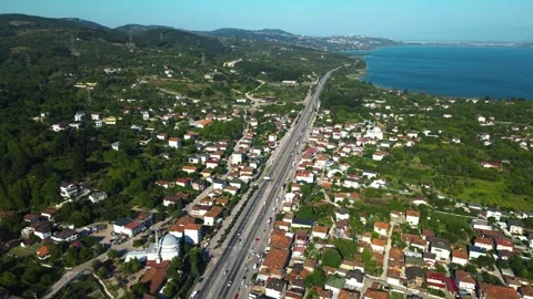 Aerial View Along Main Road Through Coastal Town Stock Footage 342345737