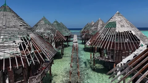 Aerial View Along Row of Abandoned Overwater Bungalows with Damaged Wooden 스톡 동영상 345007410