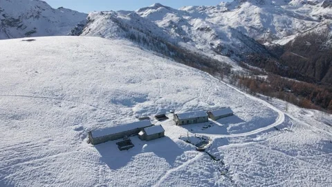Aerial view of alpine building in winter at the top of snowy mountains Stock Footage 215872826