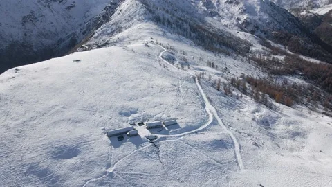Aerial view of alpine building in winter at the top of snowy mountains Stock Footage 215872880