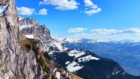 Aerial View of Alpine Cliffs and Snowy Valley Landscape Photos