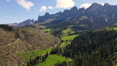 Aerial view of alpine meadows below Dolomites peaks Stock Footage 301559522