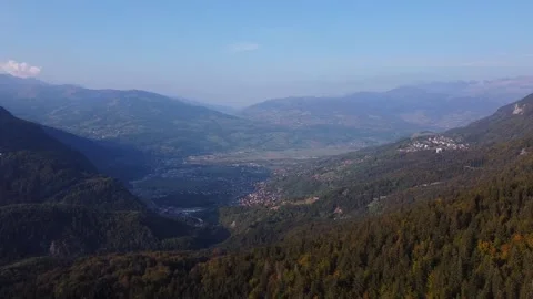 Aerial view from an alpine valley to a mountain range, fall colors. Video stock 140782353
