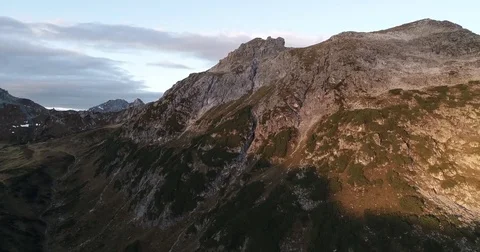 Aerial view of alps mountain during autumn summer sunrise. Drone moving sideways Stock Footage 80961576