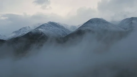 Aerial view of altai mountain range with autumn forest through low clouds Stock Footage 100040357