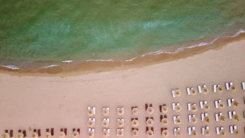 Aerial view of an amazing empty sand beach with straw beach umbrellas Stock Footage 196148409