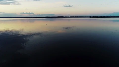Aerial view. Amazing sky reflected in water. Beautiful sunset over the lake. Stock Footage 104018677