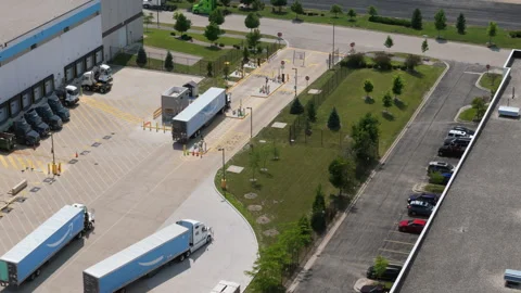 Aerial view of an Amazon logistics and distribution facility with semi trucks Stock Footage 346020327