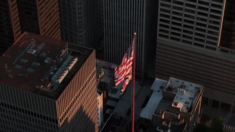 Aerial view of the American Flag flying above downtown Baltimore Stock Footage 345288451