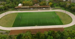 American football arena with yellow goal post, grass field and