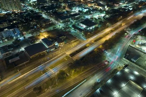 Aerial view of american freeway intersection at night with fast driving cars and 스톡 사진