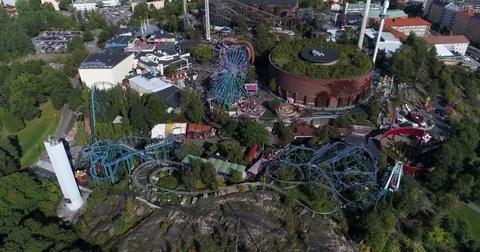 Aerial view of amusement park with roller coaster and ferris wheel. Drone down Stock Footage 80230990