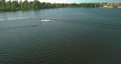 Aerial view of the anchorage of the cable car wake park, and an athlete cutting Stock Footage 159658576