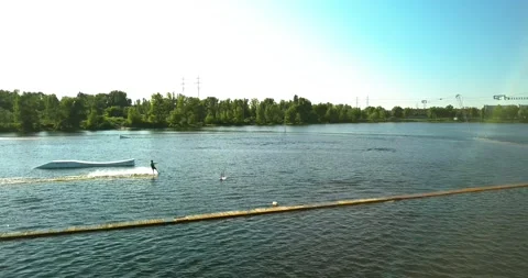 Aerial view of the anchorage of the cable car wake park, and an athlete cutting Stock Footage 172092779