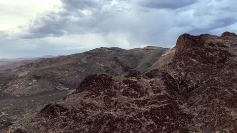 Aerial View of Ancient Basalt Mountain Formed by Volcanic Eruption Under Moody Stock Footage 341680022