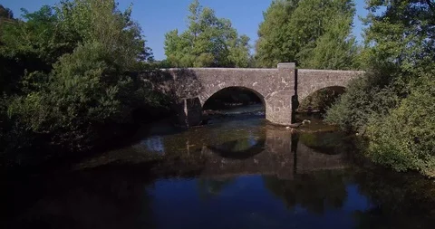 Aerial view of Ancient bridge over river Stock Footage 99178994